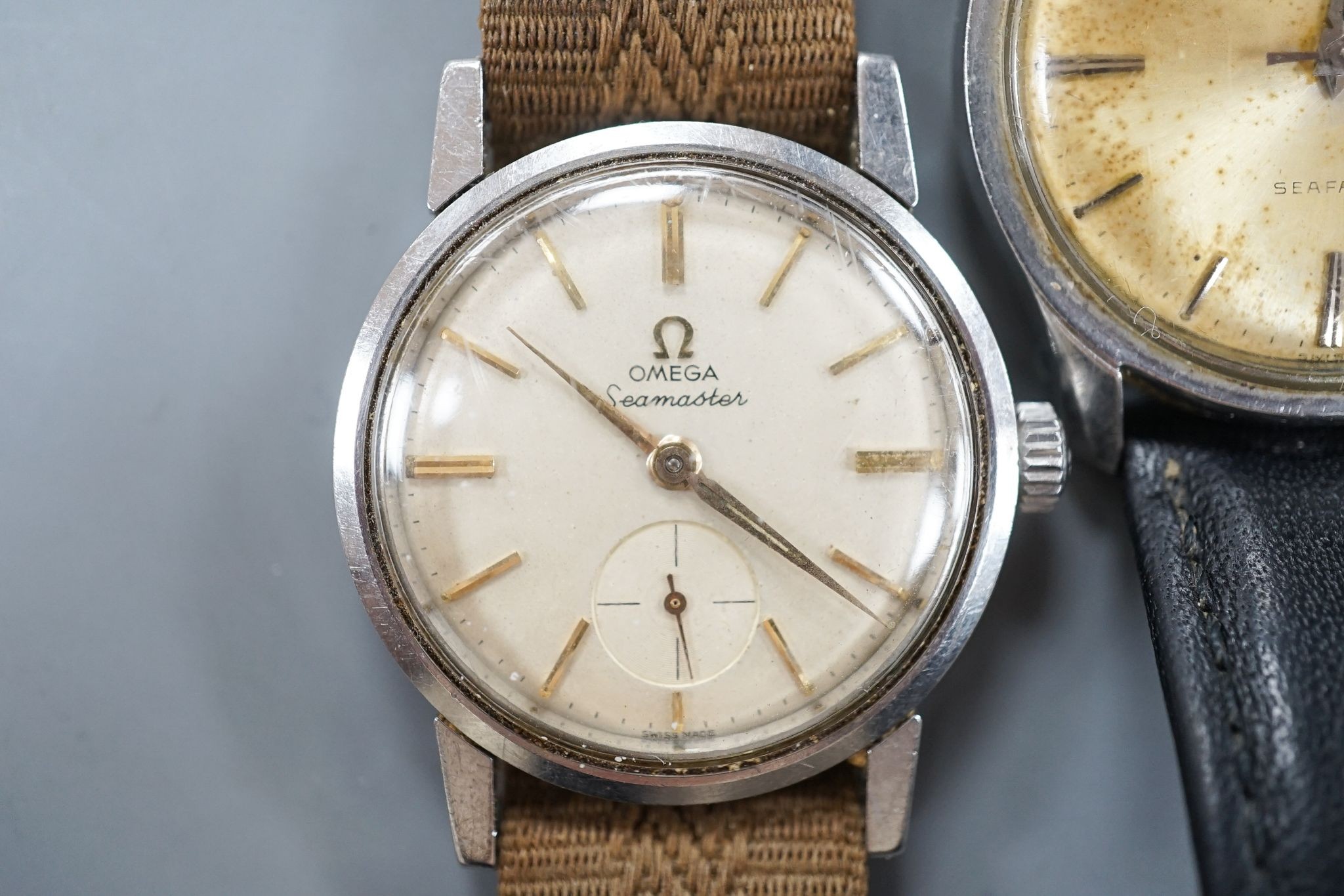 A gentleman's stainless steel Omega Seamaster manual wind wrist watch and two other watches.